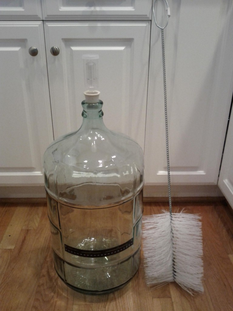 glass carboy with rubber stopper airlock and brush